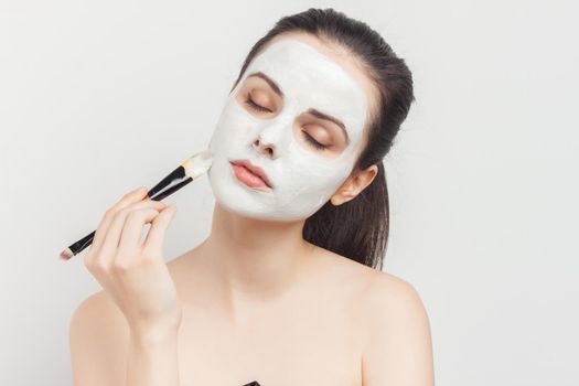 pretty woman with face cream mask skin care naked shoulders. High quality photo