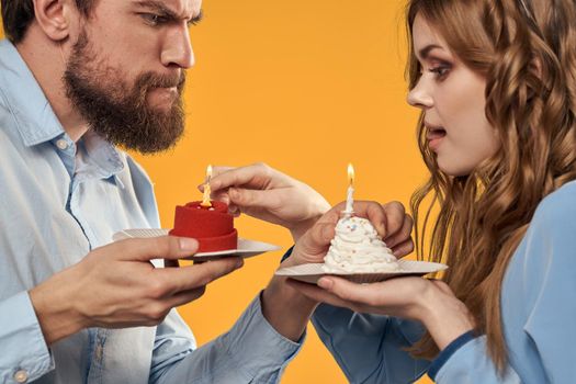 Birthday party man and woman fun yellow background cap holiday. High quality photo