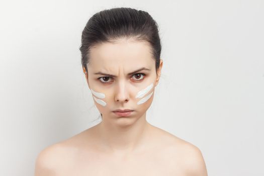 brunette with cream face mask bare shoulders smile. High quality photo