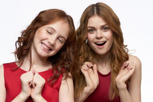Cheerful mom and daughter hugs joy lifestyle family light background. High quality photo