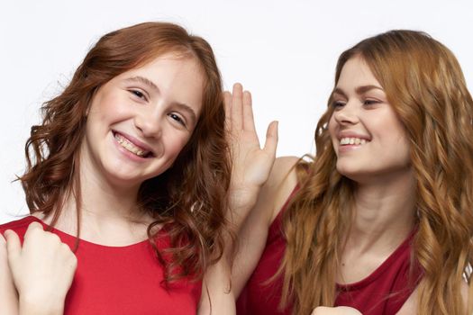 Cheerful mom and daughter hugs joy lifestyle family light background. High quality photo