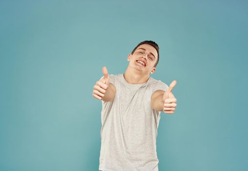 handsome man t shirt emotions hand gestures blue background. High quality photo