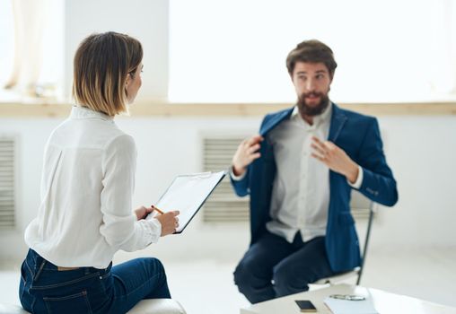 A man in a suit at a psychologist's office near the window. High quality photo