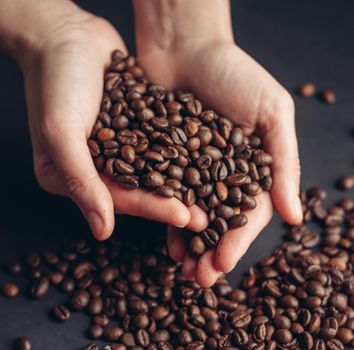 coffee beans in hands aroma morning vigor drink. High quality photo