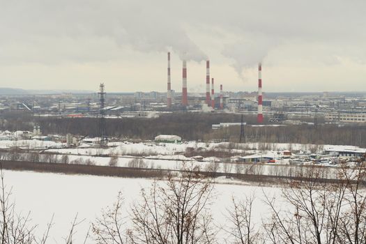 Industrial city by the river in winter. The infrastructure of the port metropolis, factories, factor. High quality photo