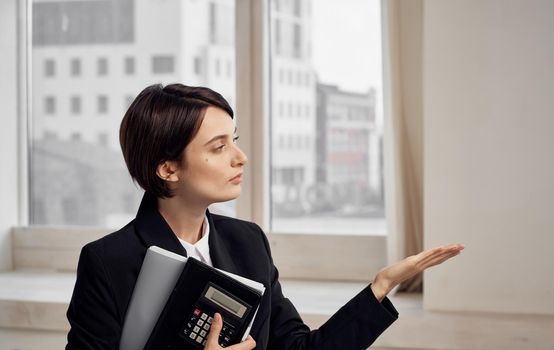 finance model woman in black jacket with documents in hands. High quality photo