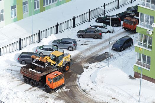 Nizhny Novgorod, Russia, Gagarin Avenue 101 Corpus 1, 2021.03.02 Snow removal in the yard of an apartment building and on the streets of the city with special snowplows. . High quality photo