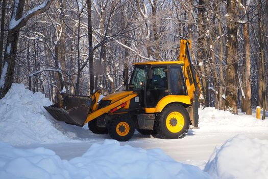 Snow removal with special equipment. Winter, lots of snow. Special equipment for cleaning snow from the street. High quality photo