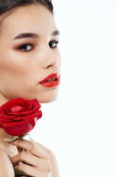 Side view of romantic woman with red flower near face. High quality photo