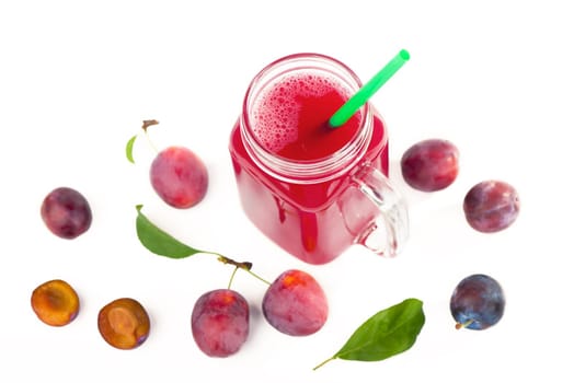 plum juice in a glass with fresh plum fruit isolated on white background.