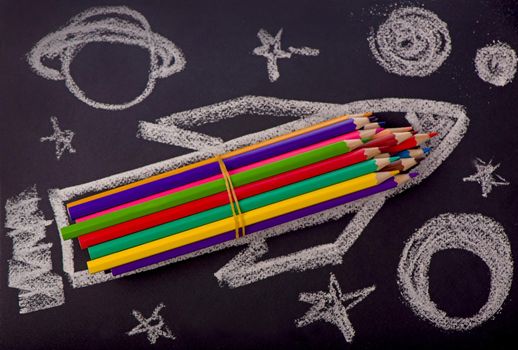 School supplies on blackboard background.