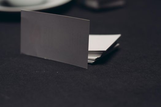 white business cards on dark table and office finance. High quality photo