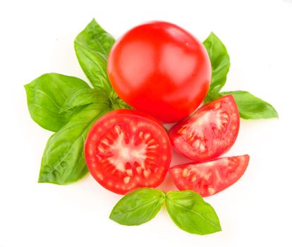 Tomatoes and basil leaves isolated on white close up.