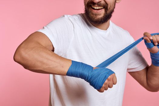 sports man boxing bandage pink workout background. High quality photo