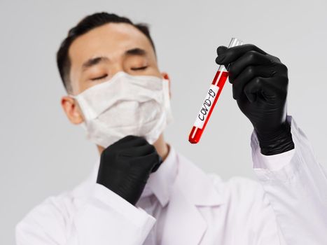 asian man wearing black gloves blood test diagnostics laboratory . High quality photo