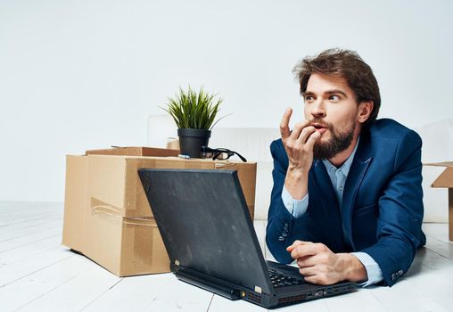Business man in front of laptop boxes with office work lifestyle things. High quality photo