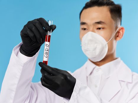 Asian male male protective suit black gloves covid-19 blood test examination research. High quality photo