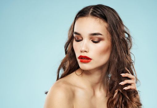 Sexy model with red lips nude shoulders makeup cropped look. High quality photo