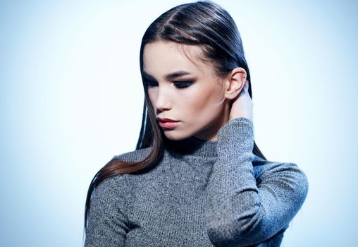 Portrait of a brunette woman on a light background cropped view close-up. High quality photo