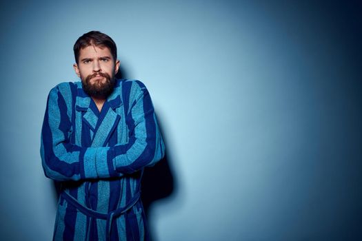 man in blue robe emotions lifestyle morning studio. High quality photo