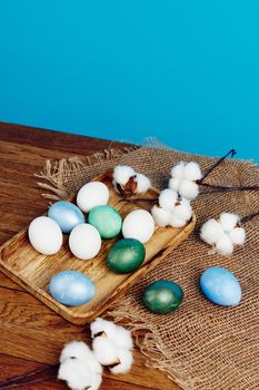 easter eggs on wooden tray decoration blue background. High quality photo