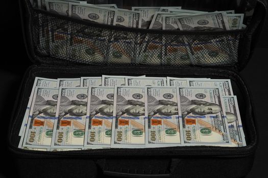 Cash American dollar in a suitcase. A suitcase of money. Business and economics. High quality photo