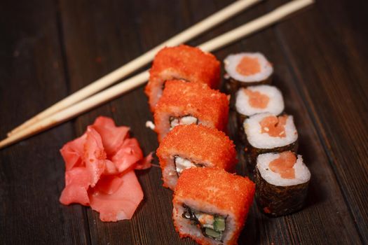 asian cuisine sushi and rolls on the table wooden sticks ginger wasabi. High quality photo