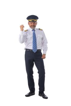 Airline pilot, aircraft commander holding fist showing yes gesture isolated on white background full length studio portrait