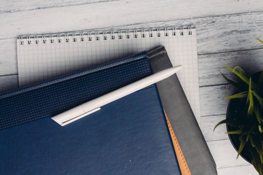 notepads documents desktop office close-up pen objects from above. High quality photo