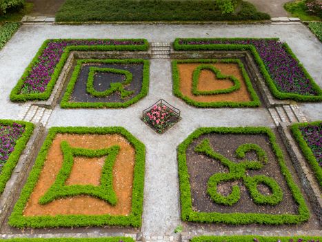 Aerial drone look to Small square in park with plants in card symbols shape