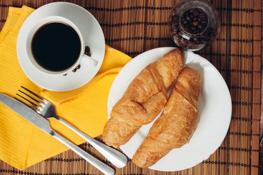 fresh croissants on the table coffee cup breakfast meal. High quality photo