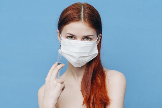 woman holding in hand on blue background naked shoulders model emotions. High quality photo
