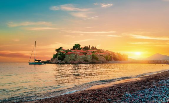 Castle Sveti Stefan on an island in the sea at sunset