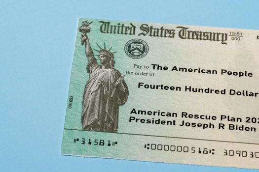 US Treasury illustrative check to illustrate American Rescue Plan Act of 2021 payment on blue background