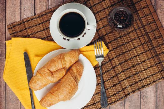 fresh croissants on a plate on the table breakfast dessert. High quality photo
