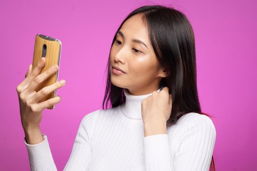 pretty woman asian appearance phone in hands communication technology cropped view. High quality photo