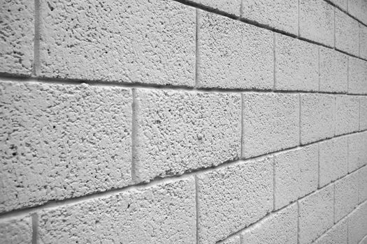 White brick block wall taken in an oblique corner. It can be used as background or texture.