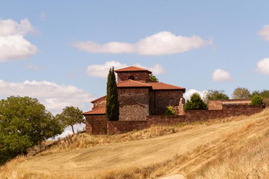 A small church on the top of a hill on a sunny day