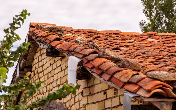 Detail of an old tiled orange roof in an old house