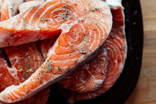 red fish sliced on a plate cooking seafood wooden background. High quality photo
