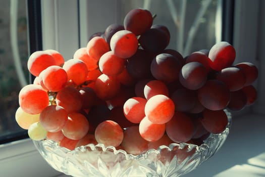 Grape in crystal vase dessert on white background