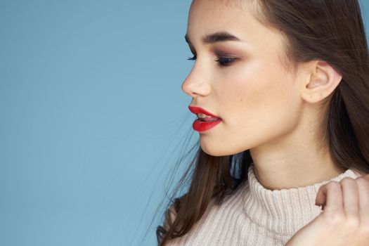 Brunette in white sweater red lips charm cropped view blue background. High quality photo