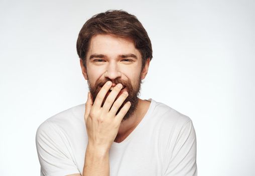 energetic man in white t-shirt gestures with his hands emotions open mouth. High quality photo