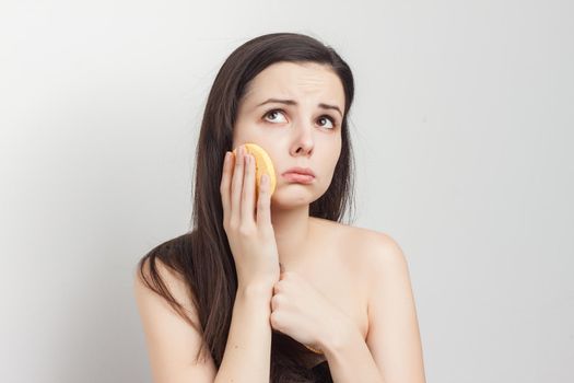 funny pomegranate with bare shoulders loose hair clean face sponges. High quality photo