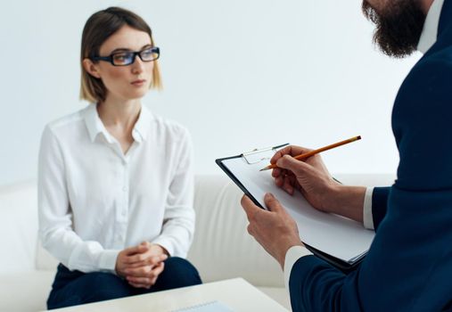 Documents woman on the couch and business man in the office. High quality photo