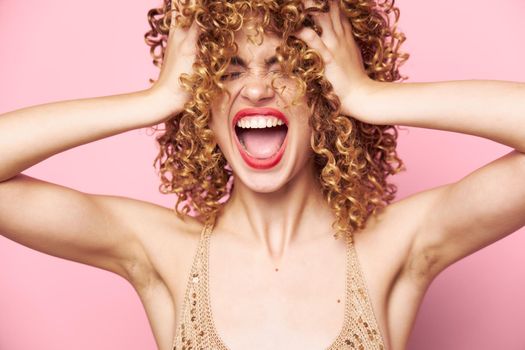 Beautiful woman Curls energy wide open mouth fashionable clothes pink background