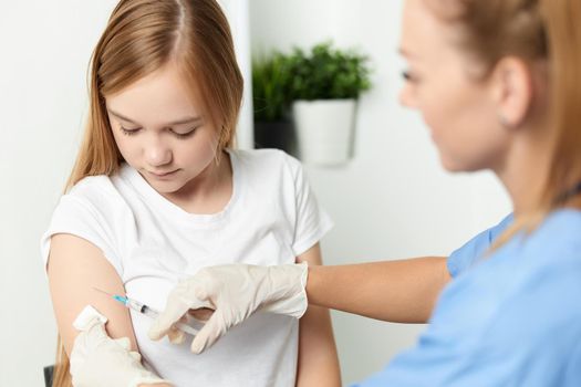 female doctor giving an injection to a child health vaccination. High quality photo