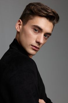 handsome young guy fashionable hairstyle attractive look black jacket close-up luxury. High quality photo
