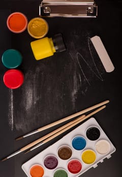 School supplies on blackboard background.