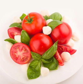 mozzarella, cherry tomatoes and fresh basil - ingredients for caprese salad.